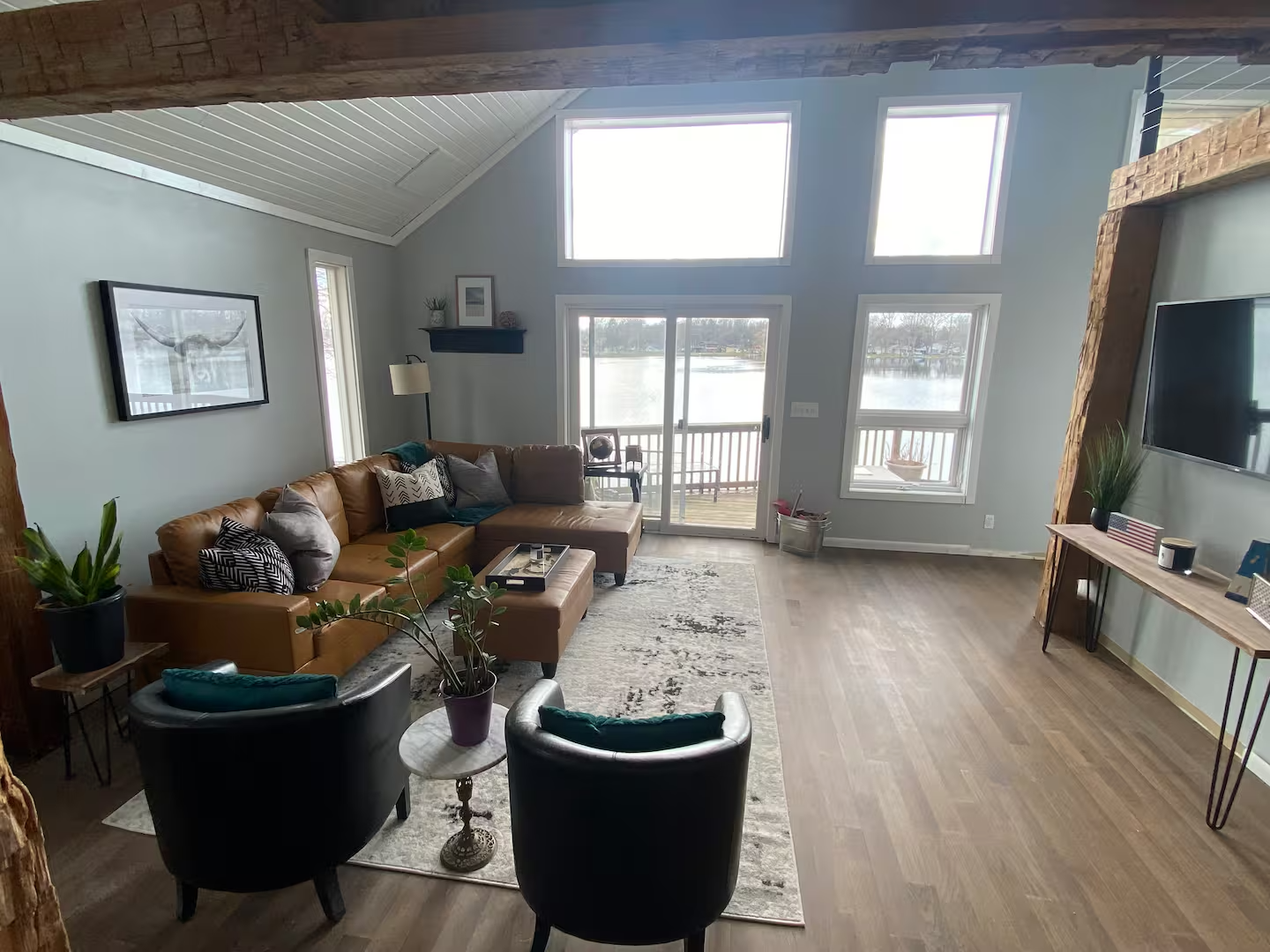 Great room with 20-foot vaulted ceilings and lake views through floor-to-ceiling windows