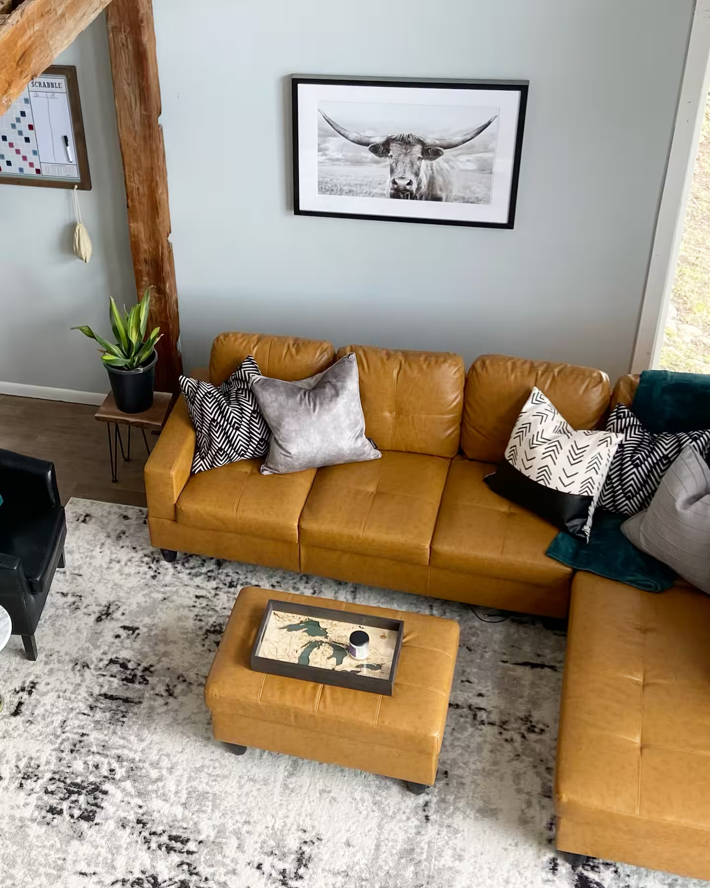 Tan leather sectional with lake-country décor